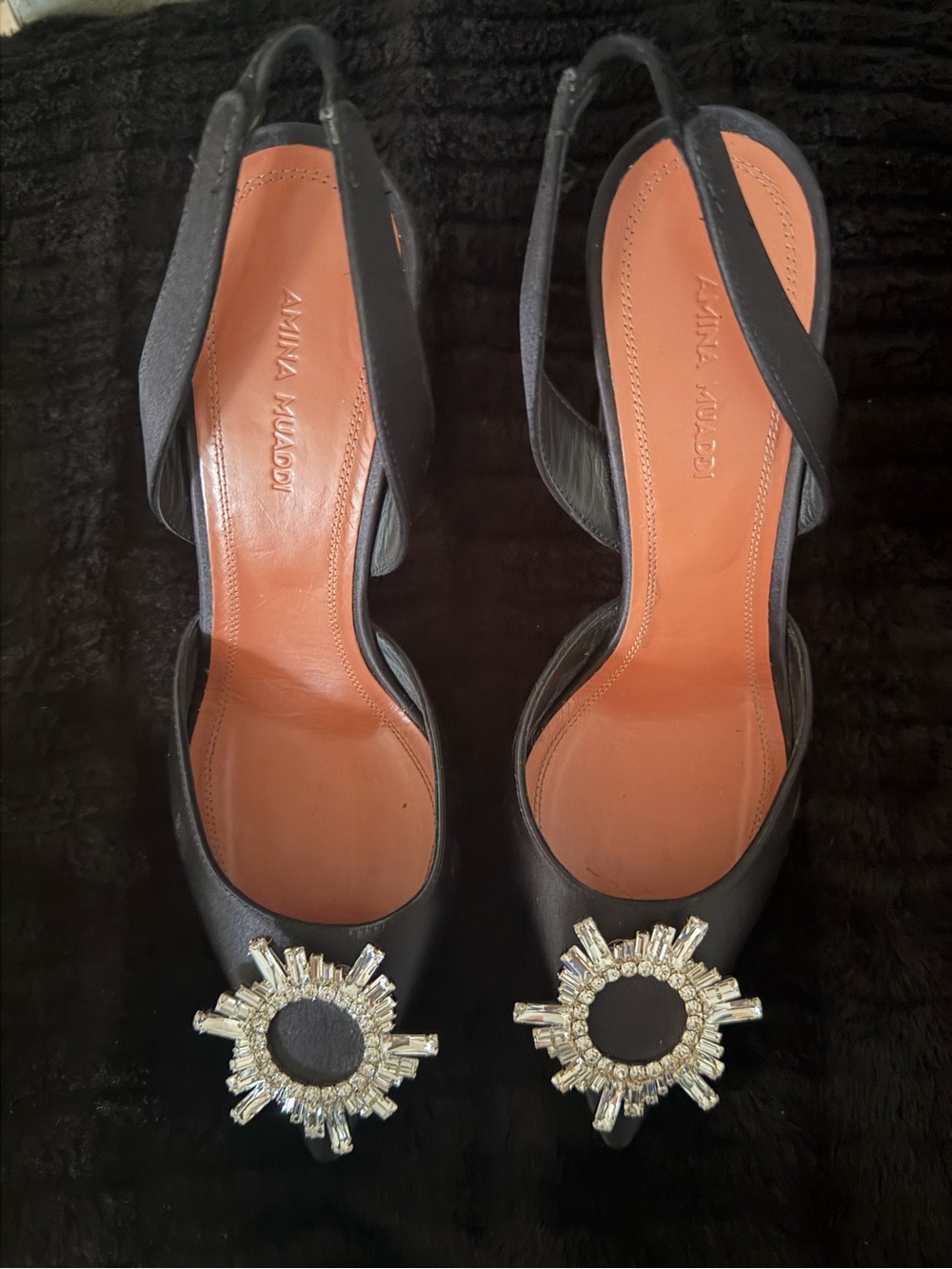 Amina Muaddi Black Slingback Heels with Crystal Sunburst Accents